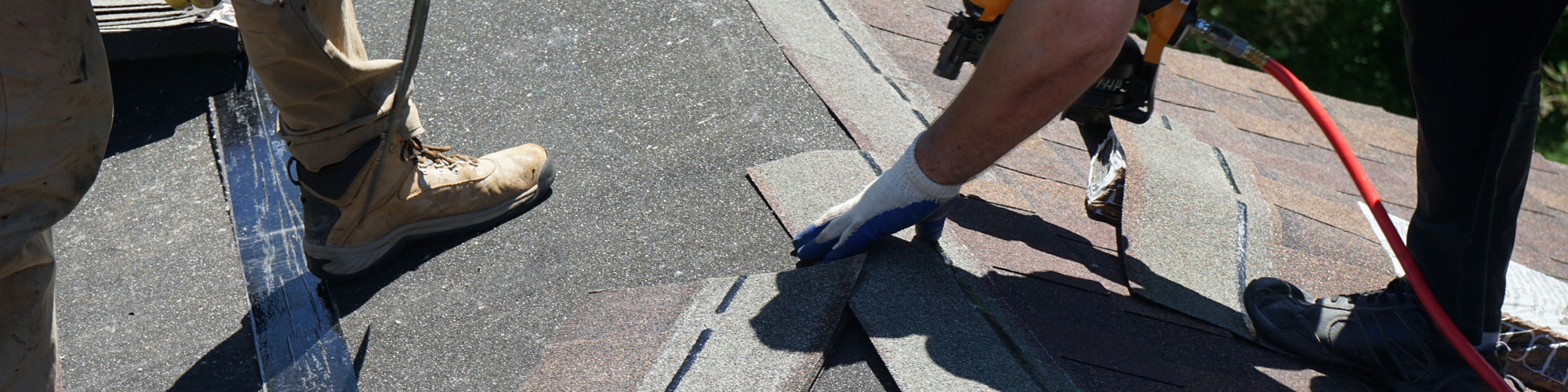 Roofer Builders Installing Asphalt Shingles Or Bitumen Tiles On A Roof Of A New House.